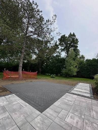 Herringbone paver patio framed by large-format pavers