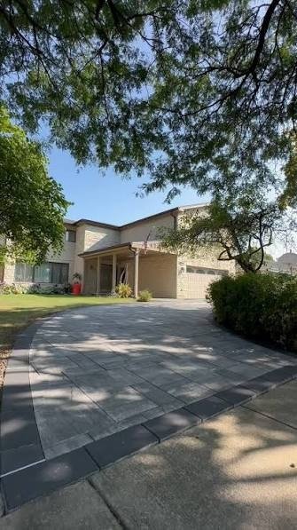 Curved paver driveway with charcoal border